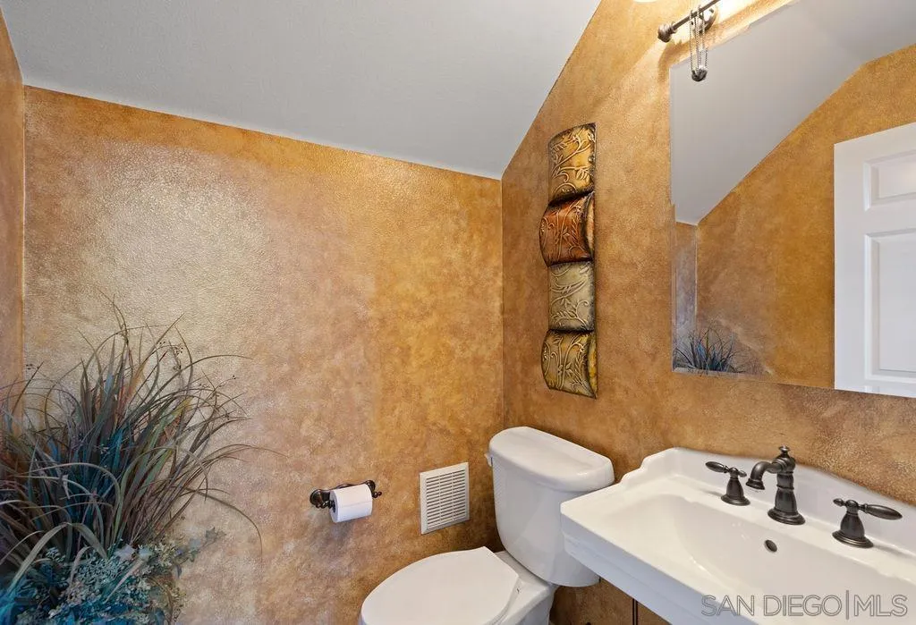 197 Double Eagle Glen Escondido, CA 92026 - Photo 6 of 70 a bathroom with a sink mirror and toilet