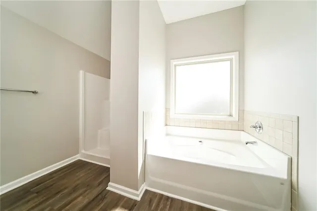 a bathroom with a bathtub and a shower