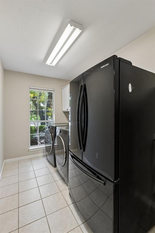 2925 Sunset Ridge McKinney, TX 75072 - Photo 30 of 33 Large utility room complete with included refrigerator, washer, and dryer, offering abundant storage space and everyday convenience for busy households.