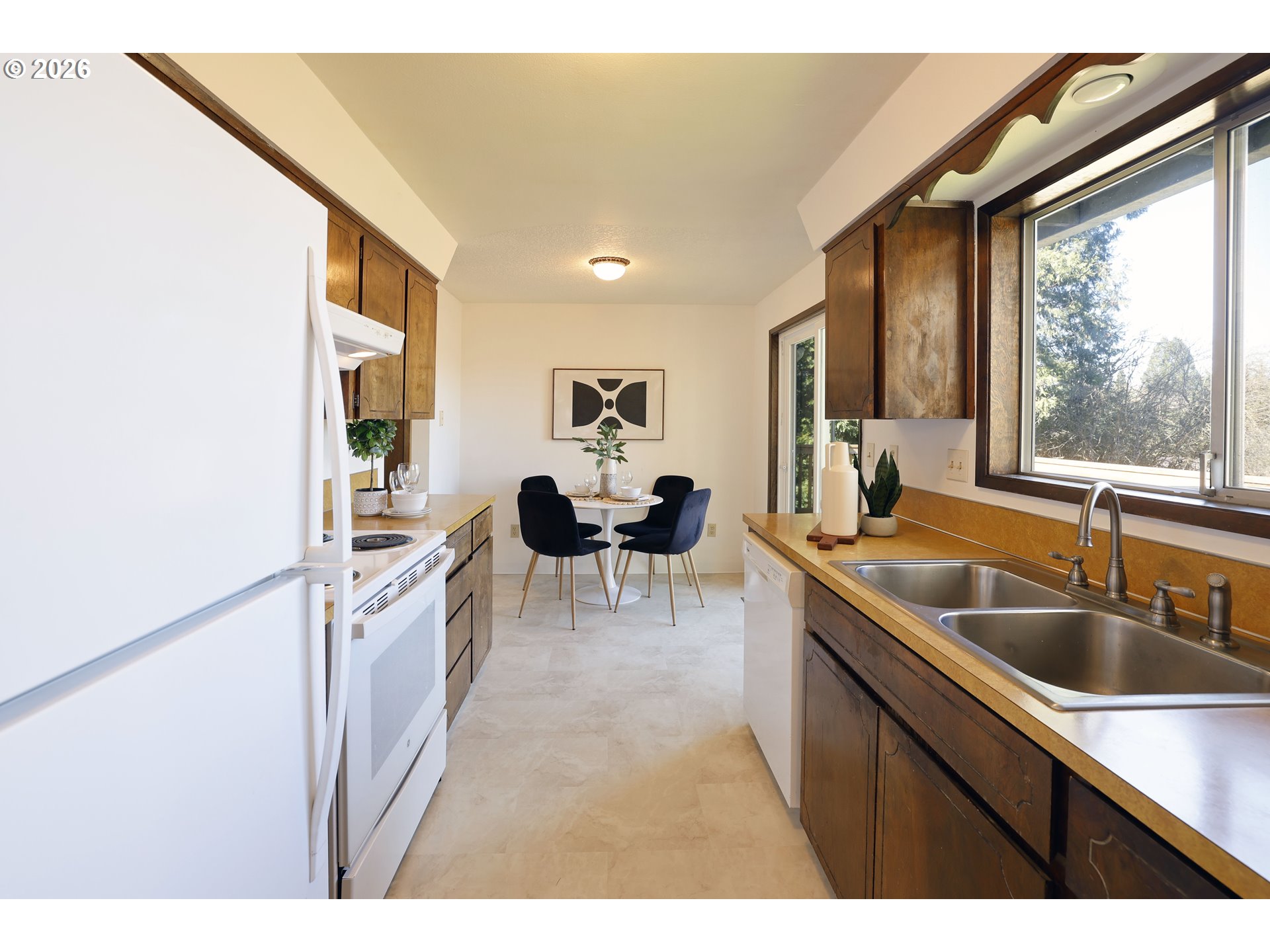 16285 Southwest Rosa Road Beaverton, OR 97007 - Photo 7 of 20 a kitchen with a sink and a refrigerator