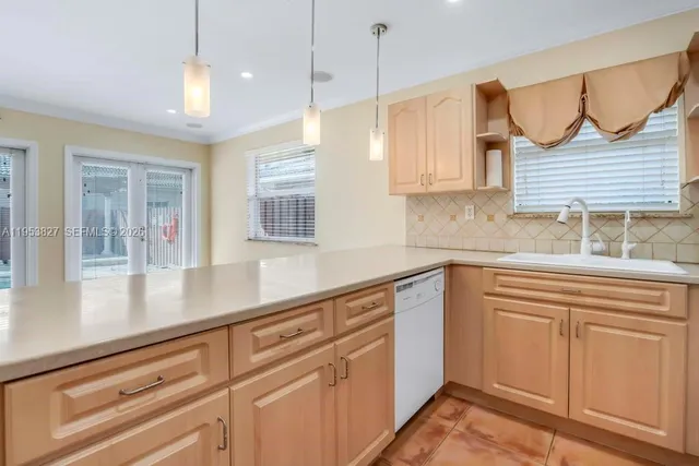 a kitchen with a sink cabinets and window