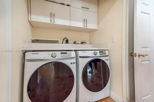 a view of multiple houses with yard and car parked