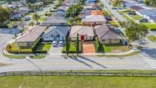 an aerial view of residential houses with outdoor space