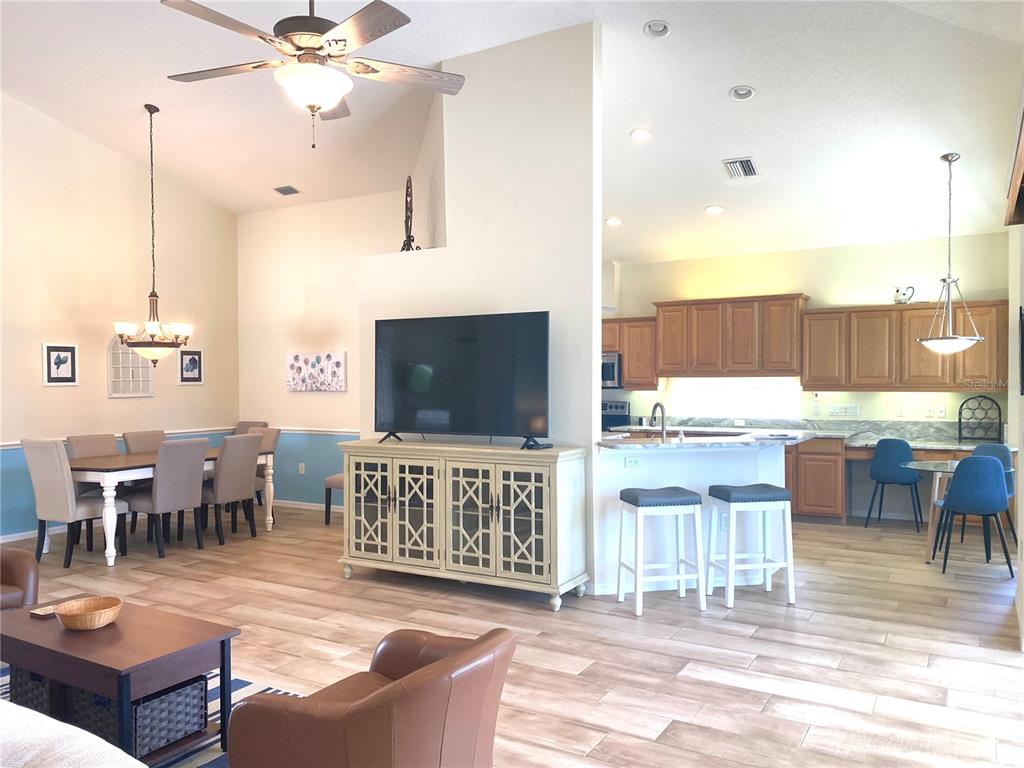 6372 Rookery Circle Bradenton, FL 34203 - Photo 11 of 46 a living room with furniture a flat screen tv and kitchen view