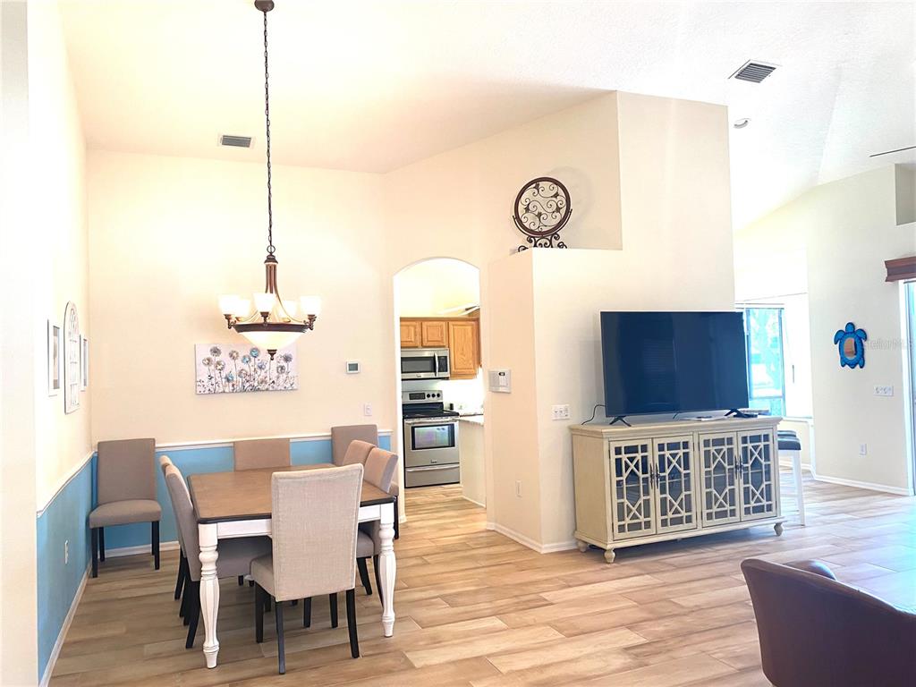 6372 Rookery Circle Bradenton, FL 34203 - Photo 13 of 46 a view of a dining room with furniture window and wooden floor