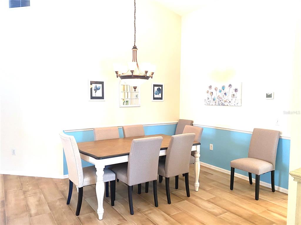 6372 Rookery Circle Bradenton, FL 34203 - Photo 14 of 46 a view of a dining room with furniture and wooden floor