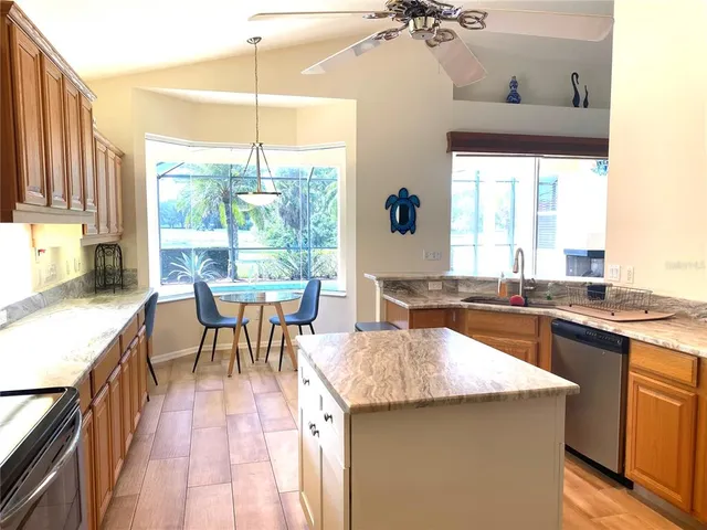 a kitchen with a table chairs stove and cabinets