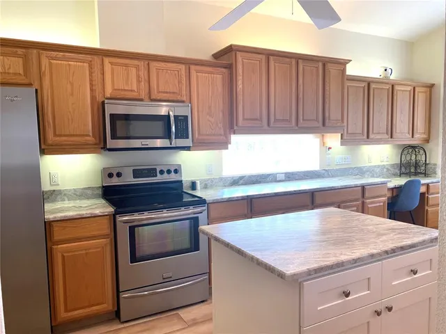a kitchen with granite countertop a stove and cabinets