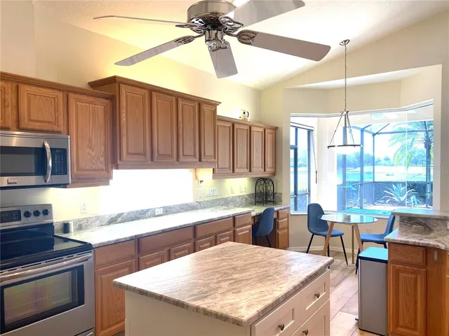 a kitchen with a stove a sink and a refrigerator