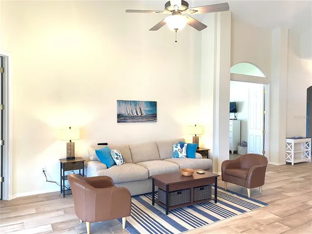a living room with furniture and a chandelier