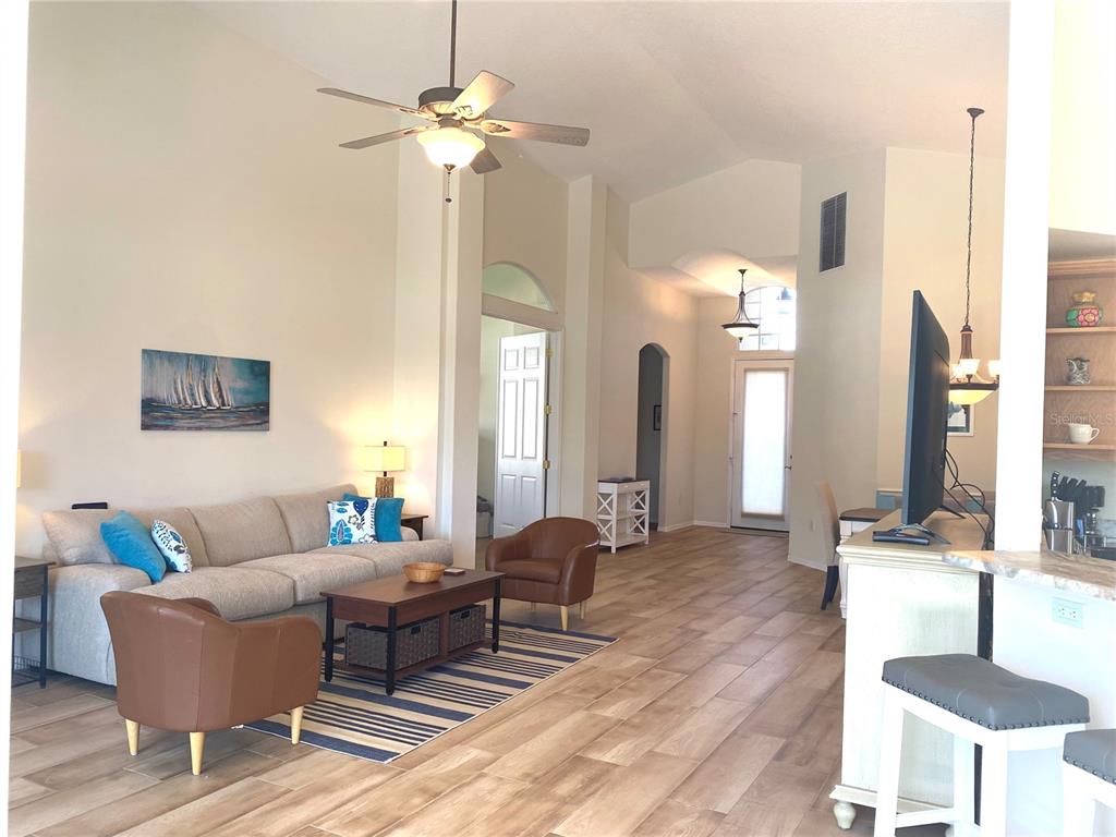 6372 Rookery Circle Bradenton, FL 34203 - Photo 25 of 46 a living room with furniture and a chandelier