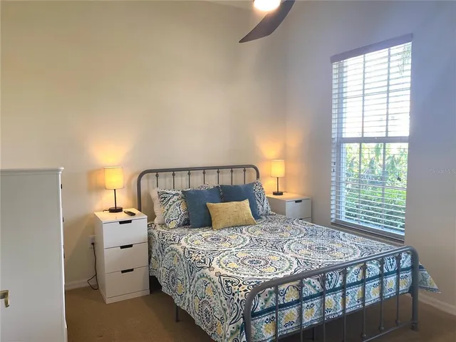 a bedroom with a large bed and a window