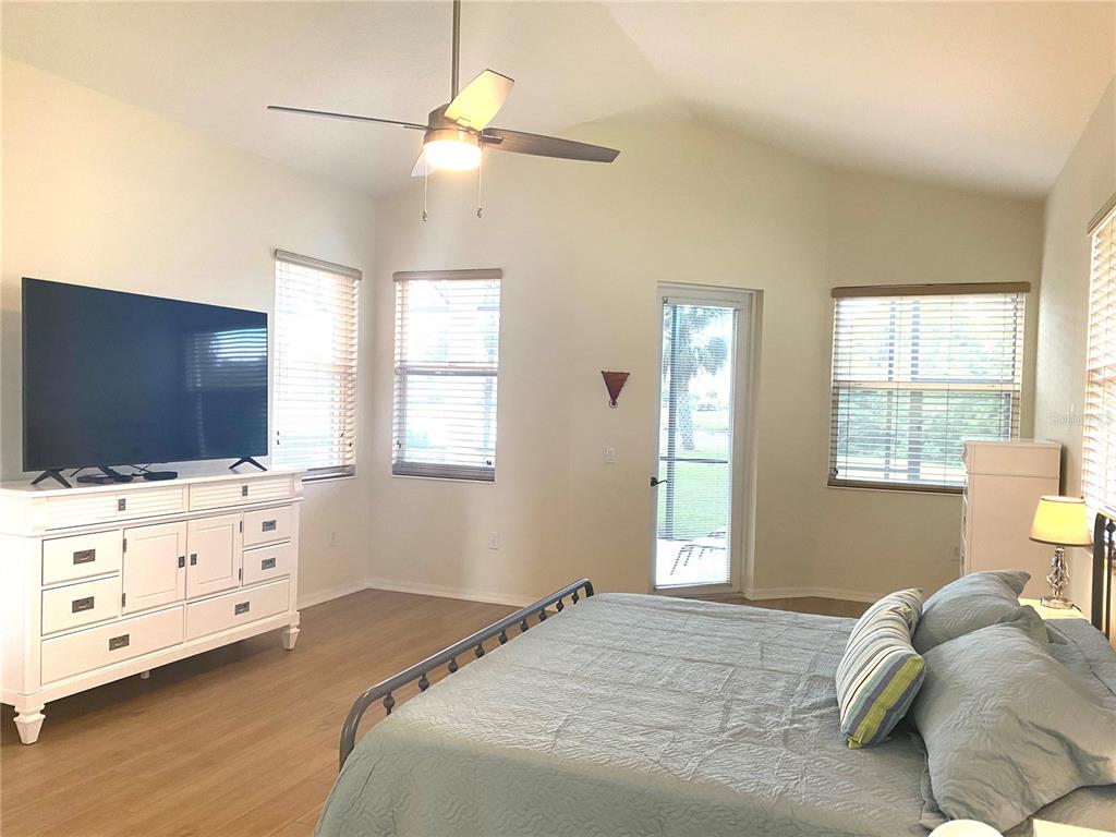 6372 Rookery Circle Bradenton, FL 34203 - Photo 32 of 46 a bedroom with a bed and a flat screen tv