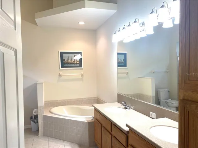 a bathroom with a bathtub a sink and a mirror