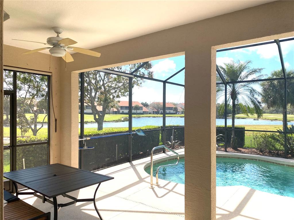 6372 Rookery Circle Bradenton, FL 34203 - Photo 44 of 46 a living room with a floor to ceiling window and wooden floor