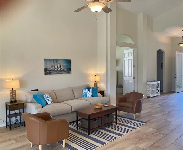 a living room with furniture a lamp and a chandelier
