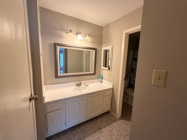 a white toilet sitting next to a shower curtain