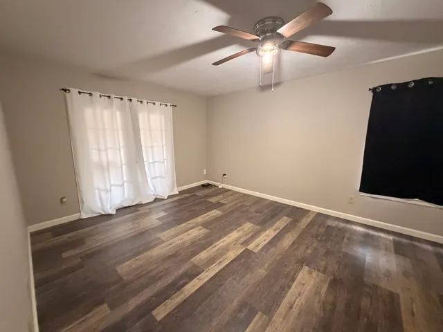 a view of room with window and ceiling fan