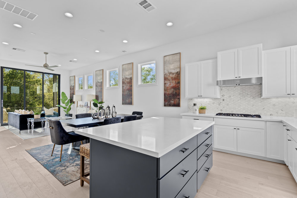 5001 Childers Path Austin, TX 78741 - Photo 1 of 40 Kitchen featuring white cabinetry, a kitchen breakfast bar, a kitchen island, and recessed lighting