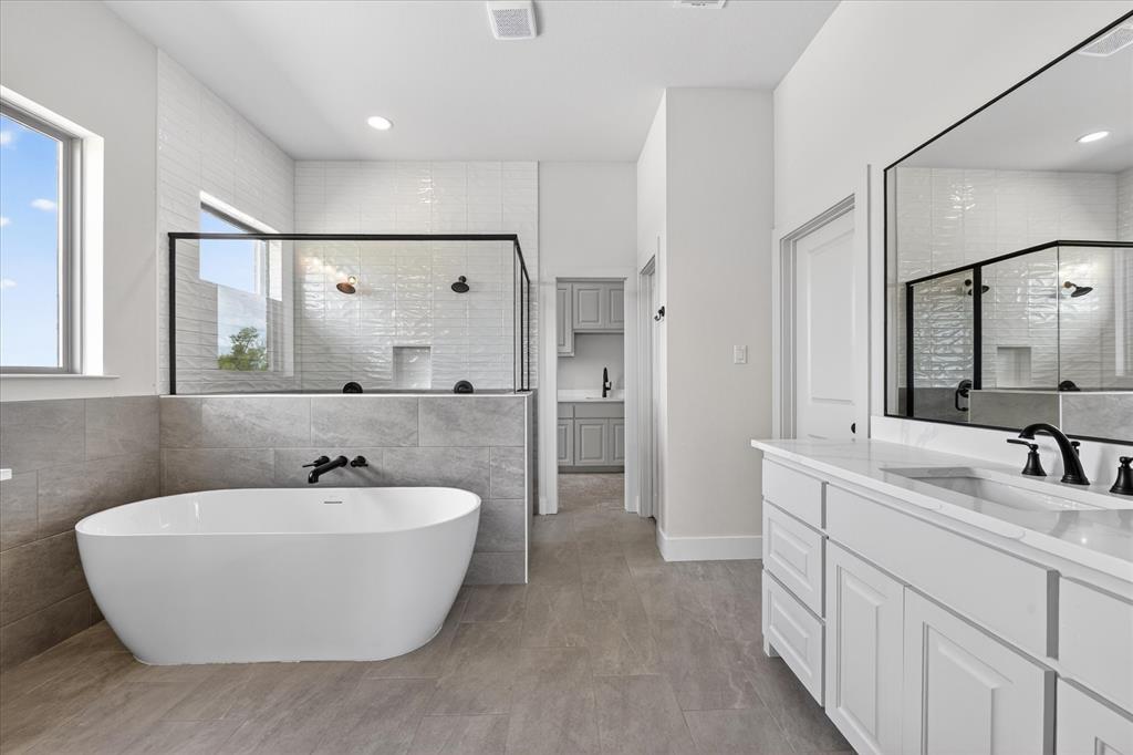 517 Longhorn Lane Springtown, TX 76082 - Photo 21 of 39 Bathroom with vanity, tile walls, a shower stall, and a soaking tub