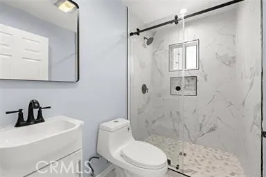 a bathroom with a sink toilet and shower