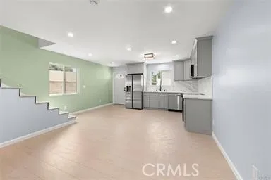 a view of kitchen with wooden floor and electronic appliances