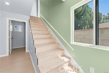a view of entryway with wooden floor and a front door