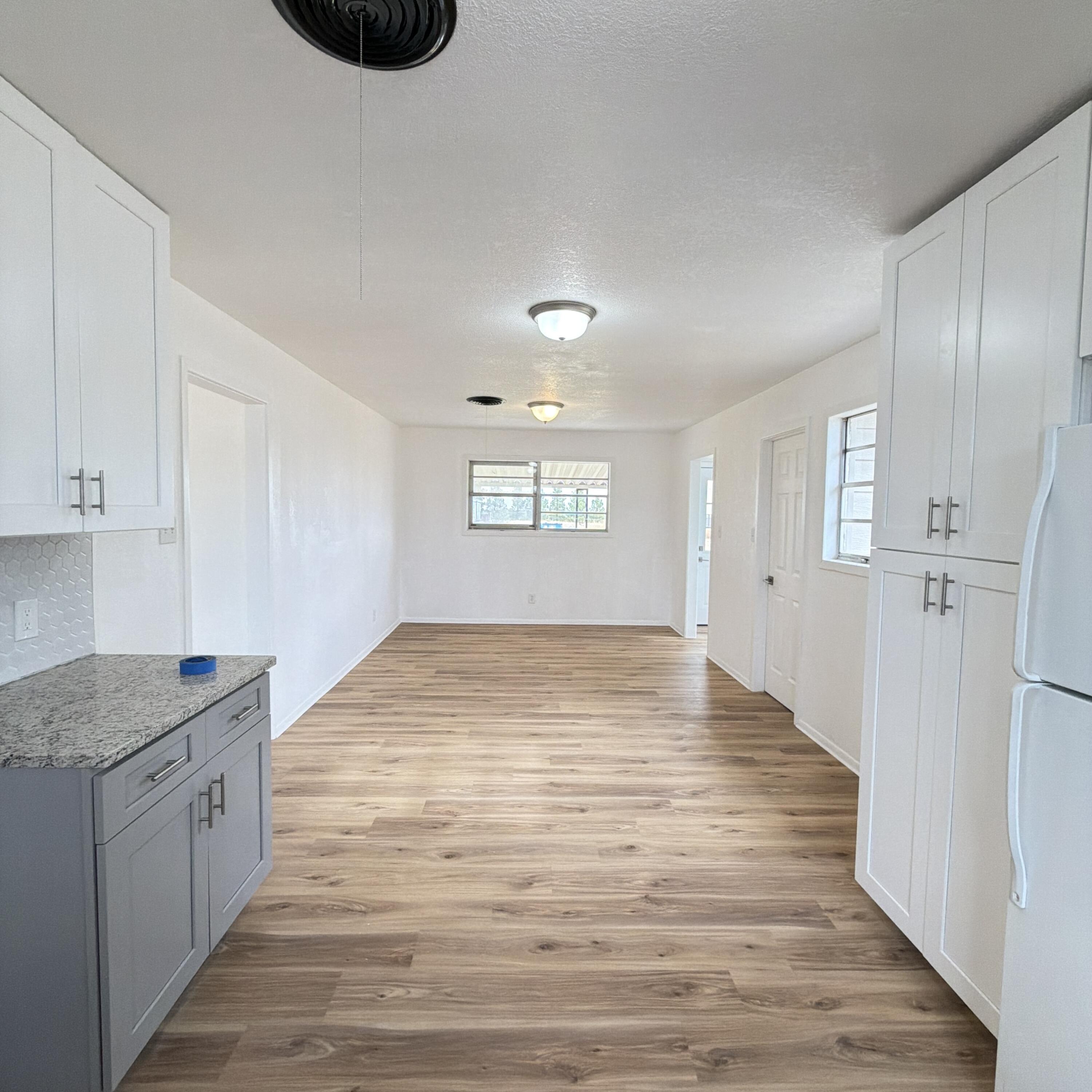 1312 Culpepper Avenue Wilson, TX 79381 - Photo 18 of 27 a view of empty room with wooden floor and window