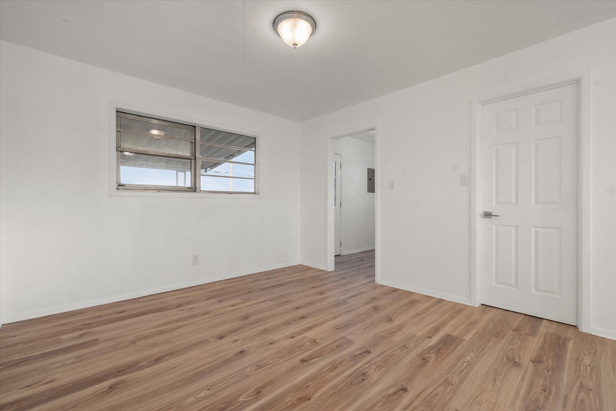 1312 Culpepper Avenue Wilson, TX 79381 - Photo 20 of 27 a view of an empty room with wooden floor and a window