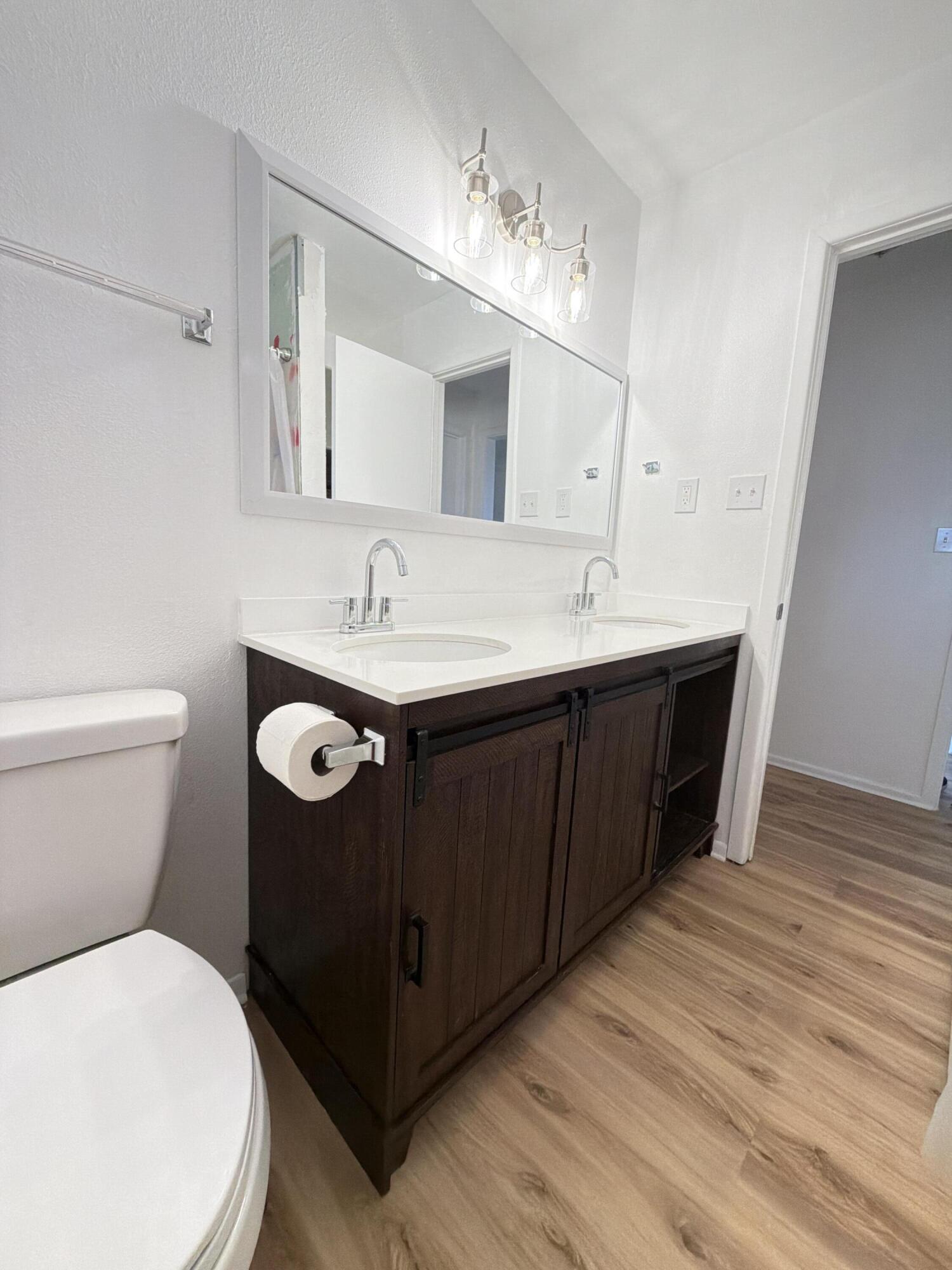 1312 Culpepper Avenue Wilson, TX 79381 - Photo 23 of 27 a bathroom with a toilet sink and mirror