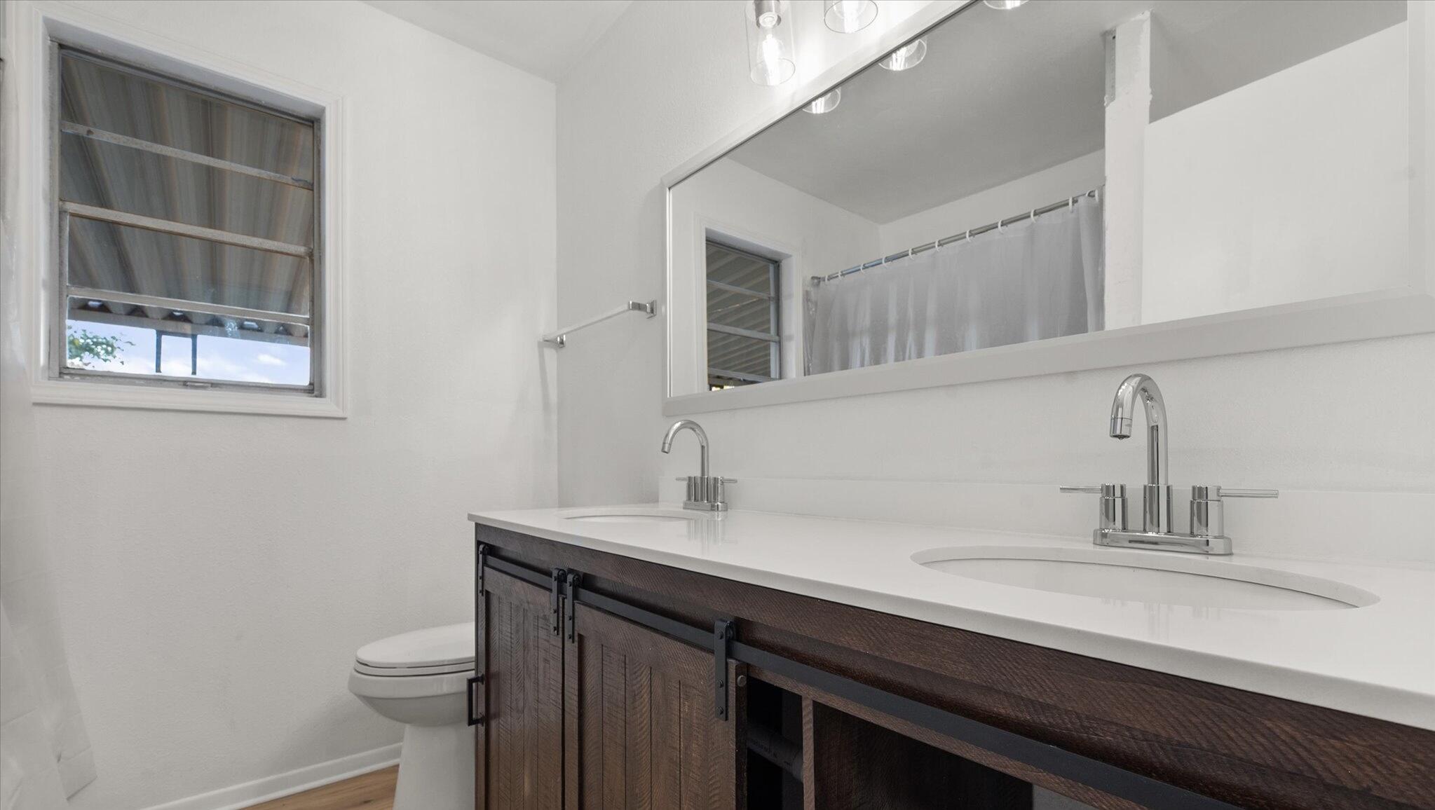 1312 Culpepper Avenue Wilson, TX 79381 - Photo 24 of 27 a bathroom with a sink a toilet and a mirror