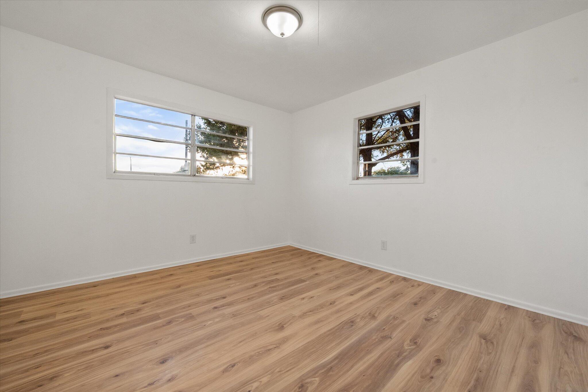 1312 Culpepper Avenue Wilson, TX 79381 - Photo 25 of 27 an empty room with wooden floor and windows