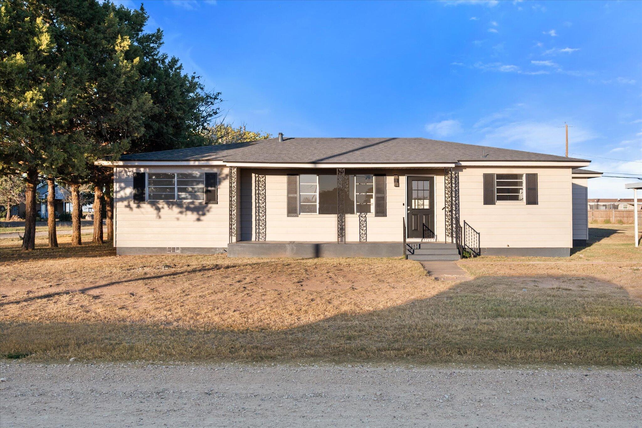 1312 Culpepper Avenue Wilson, TX 79381 - Photo 3 of 27 a front view of a house with a garden