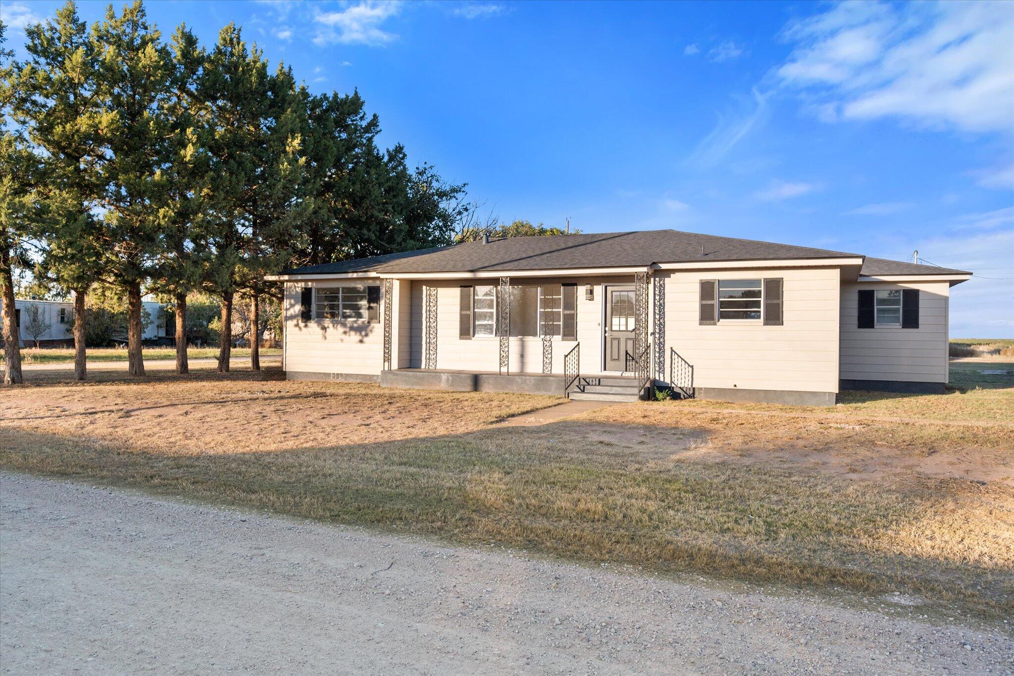 1312 Culpepper Avenue Wilson, TX 79381 - Photo 4 of 27 a front view of a house with a yard