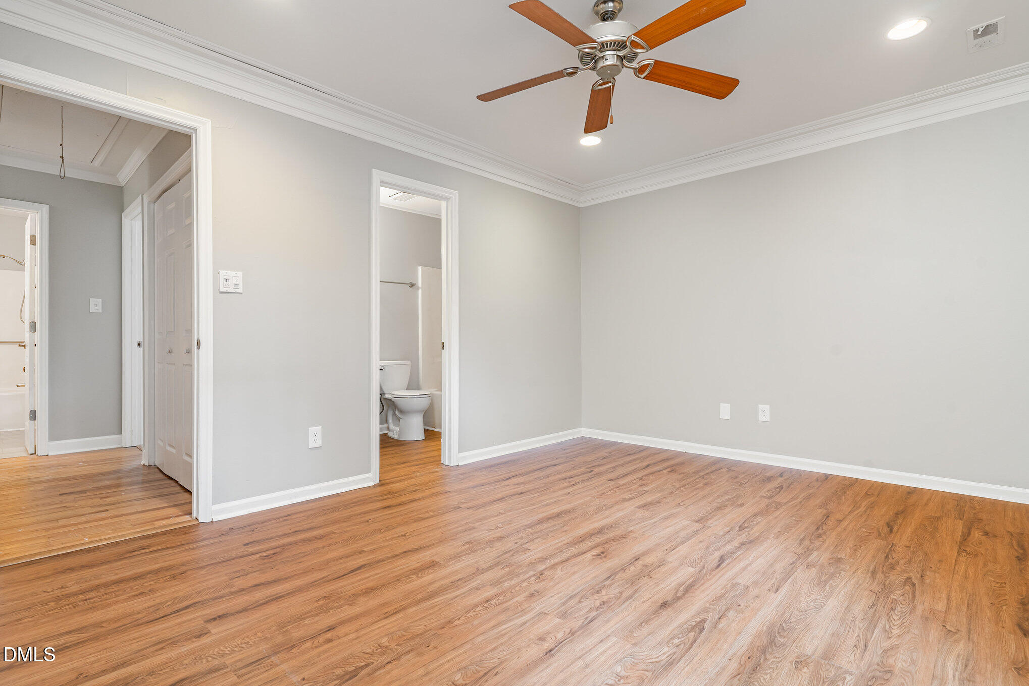 417 Applecross Drive Cary, NC 27511 - Photo 13 of 24 an empty room with wooden floor a ceiling fan and windows