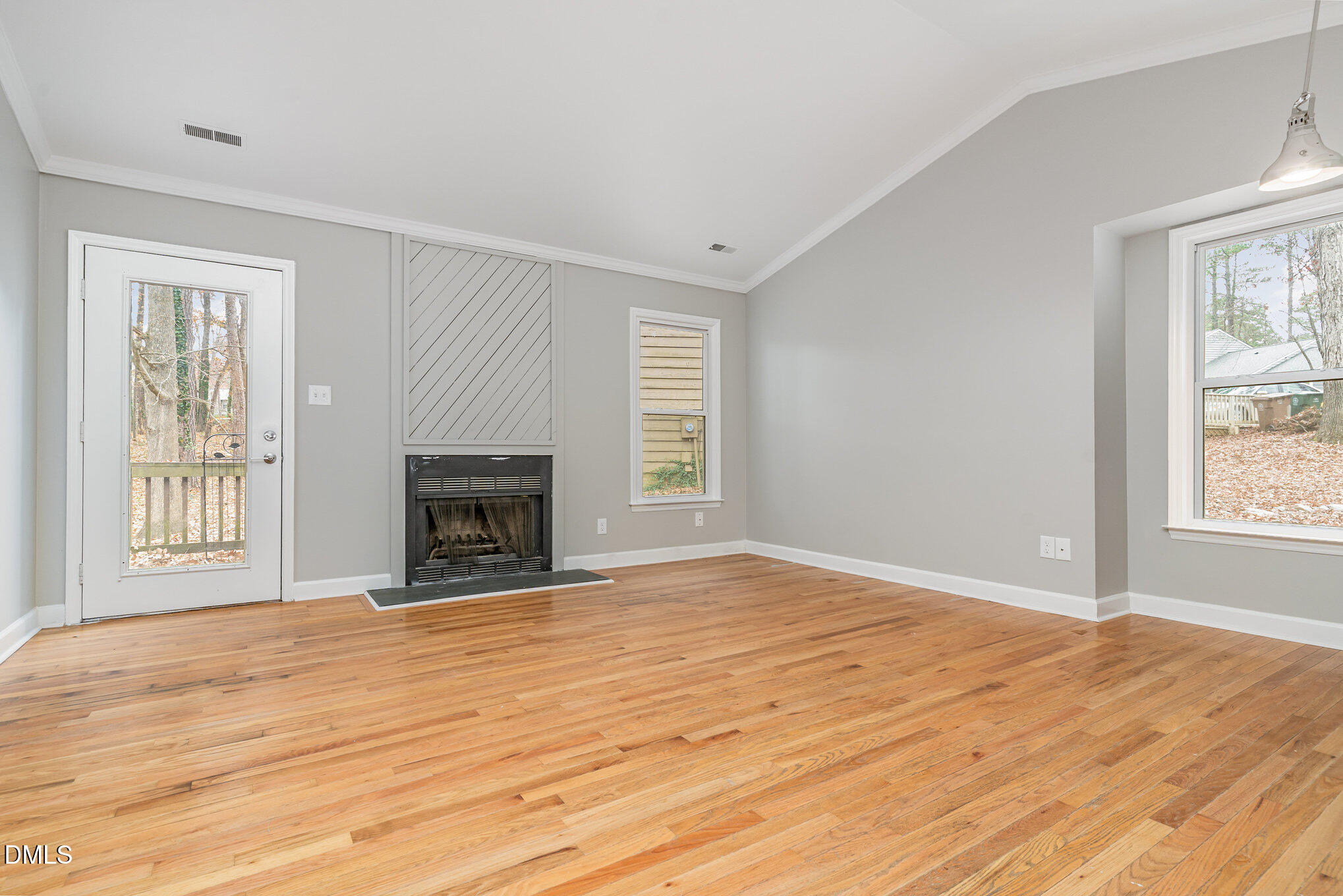 417 Applecross Drive Cary, NC 27511 - Photo 4 of 24 a view of an empty room with wooden floor and a window
