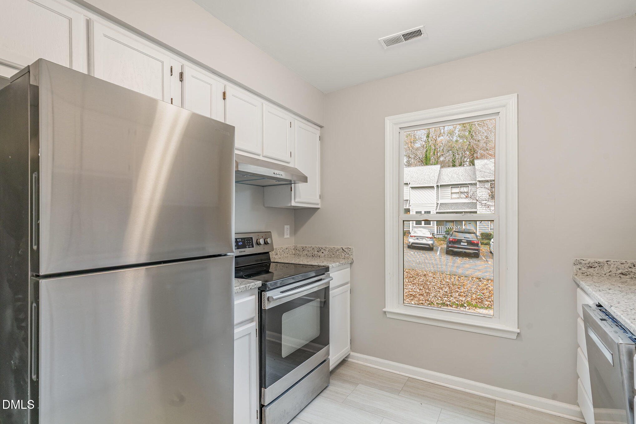 417 Applecross Drive Cary, NC 27511 - Photo 8 of 24 a white refrigerator freezer and a stove sitting inside of a kitchen