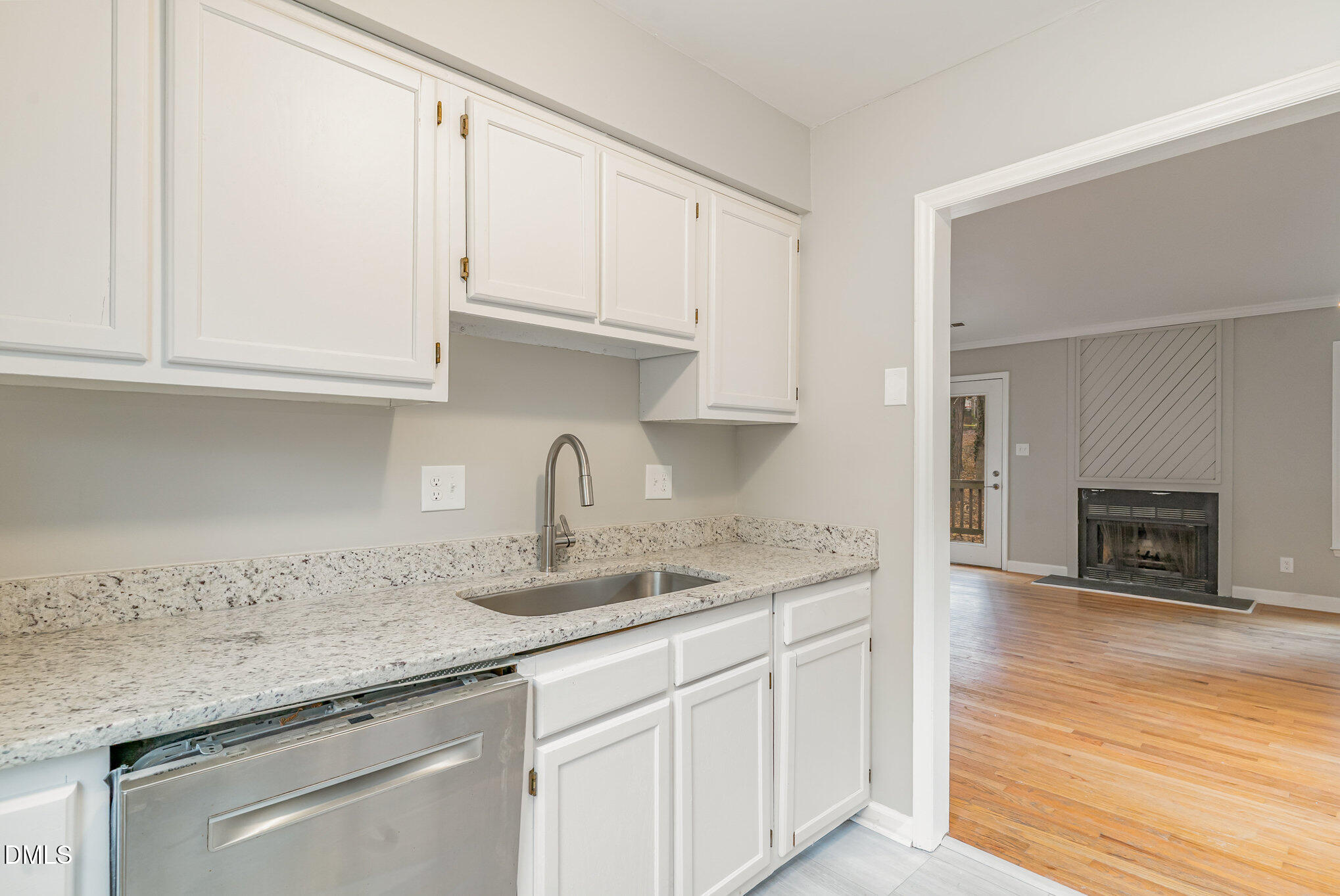 417 Applecross Drive Cary, NC 27511 - Photo 9 of 24 a kitchen with granite countertop white cabinets and a sink