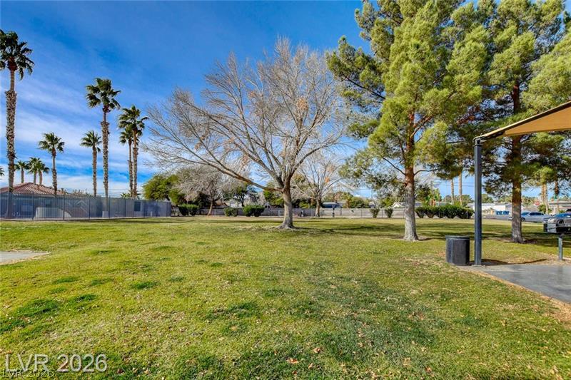 3318 North Decatur Boulevard, Unit 2152 Las Vegas, NV 89130 - Photo 43 of 58 A spacious green expanse offers abundant natural light under a clear sky.