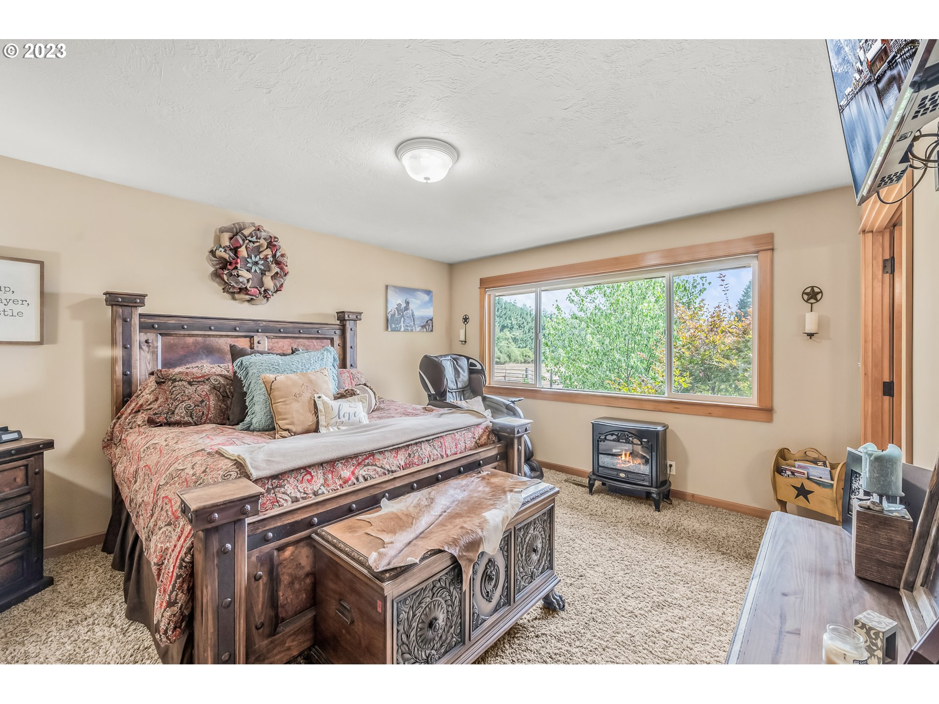 32311 Viewcrest Drive Warren, OR 97053 - Photo 18 of 46 a bedroom with a bed and a large window