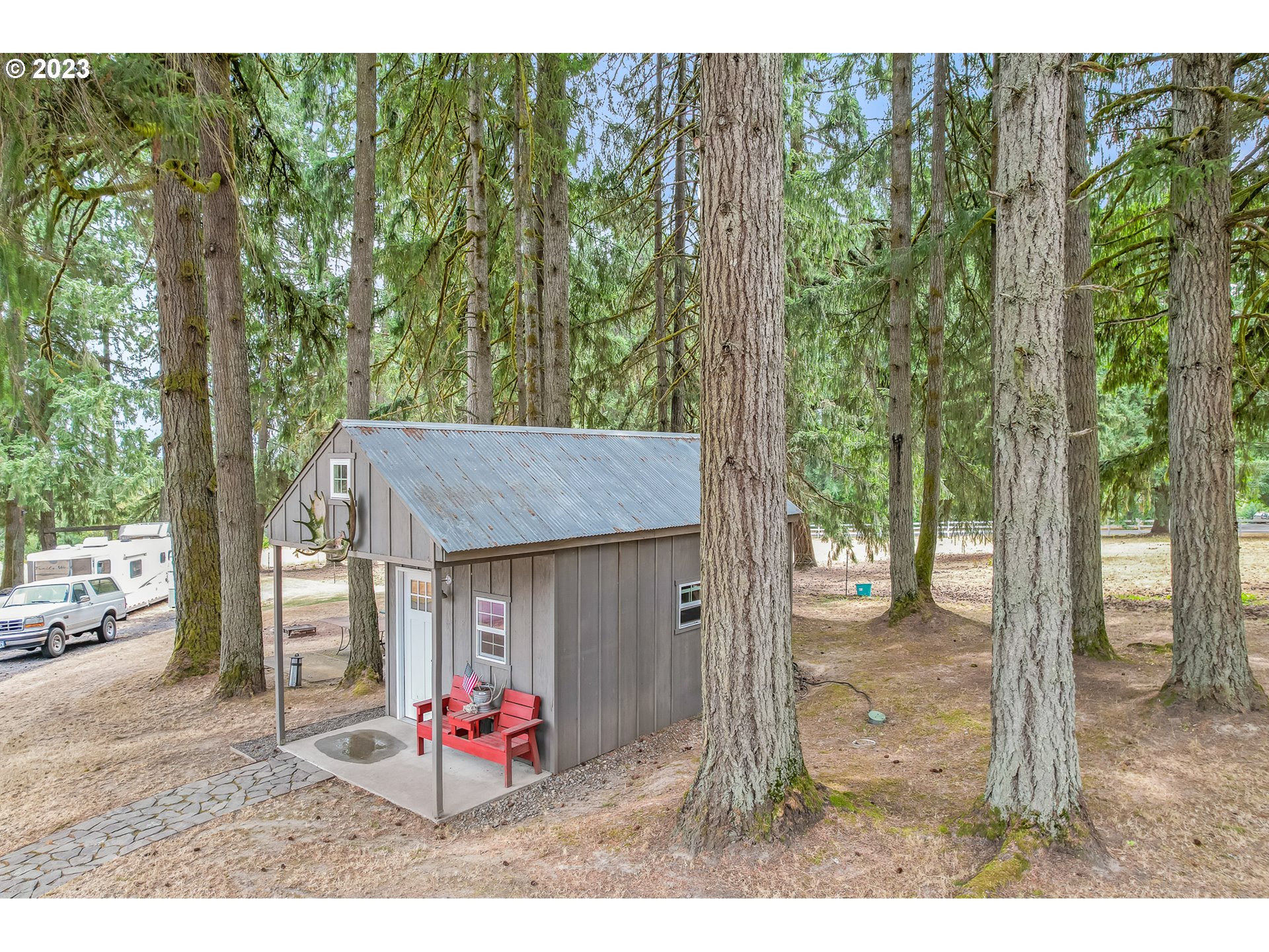 32311 Viewcrest Drive Warren, OR 97053 - Photo 26 of 46 a backyard of a house with table and chairs