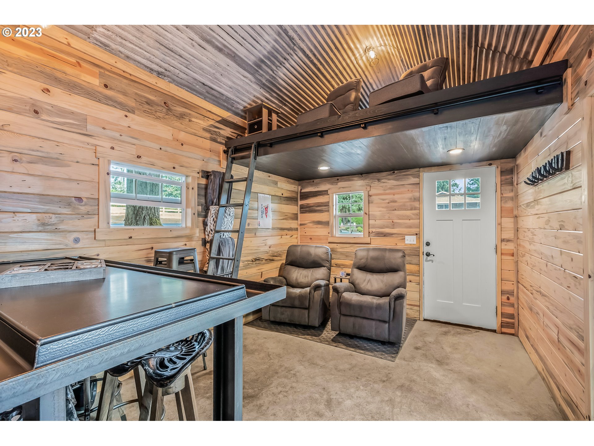 32311 Viewcrest Drive Warren, OR 97053 - Photo 28 of 46 a kitchen with a table chairs and a barbeque