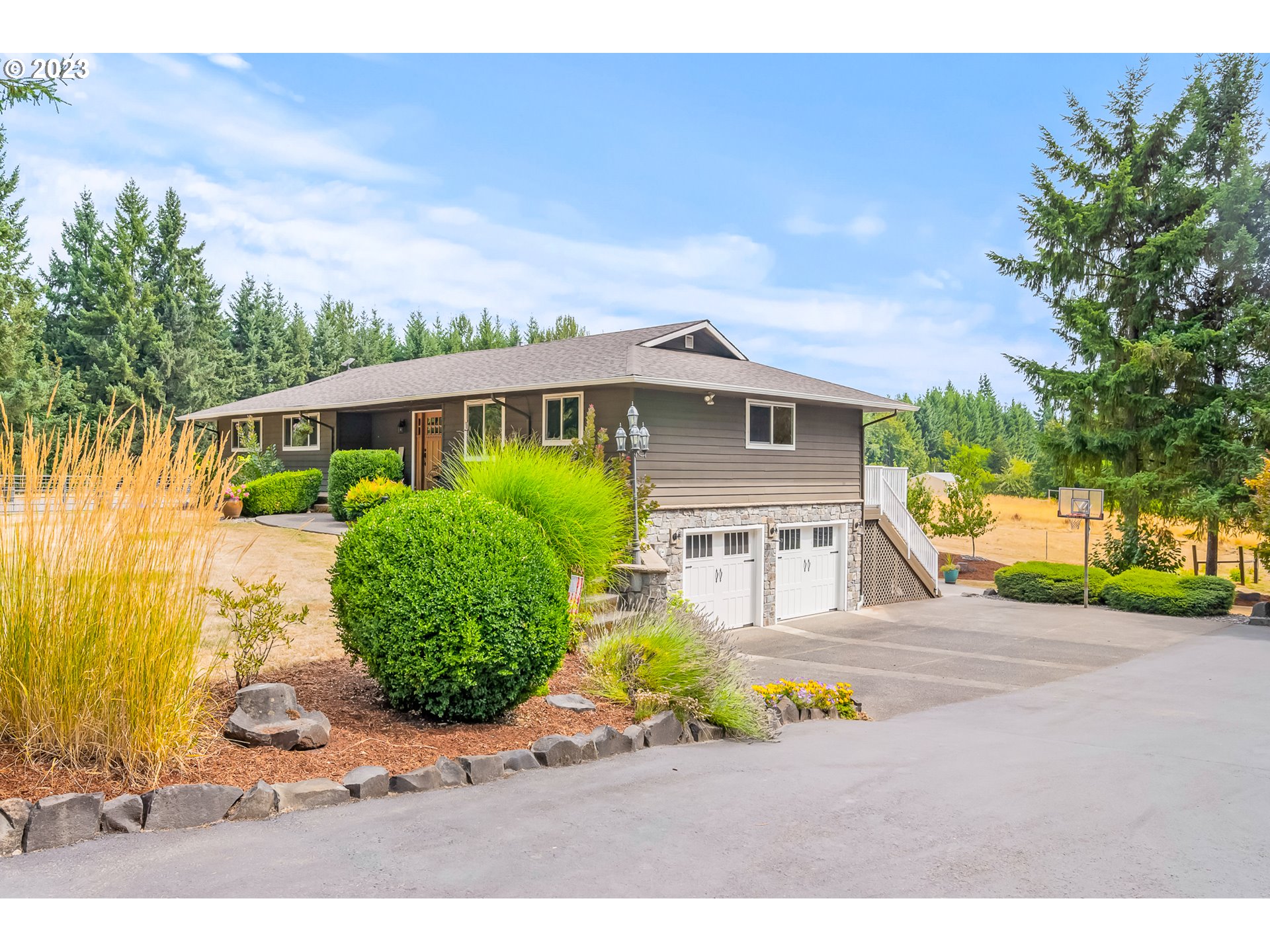 32311 Viewcrest Drive Warren, OR 97053 - Photo 5 of 46 a front view of a house with a garden