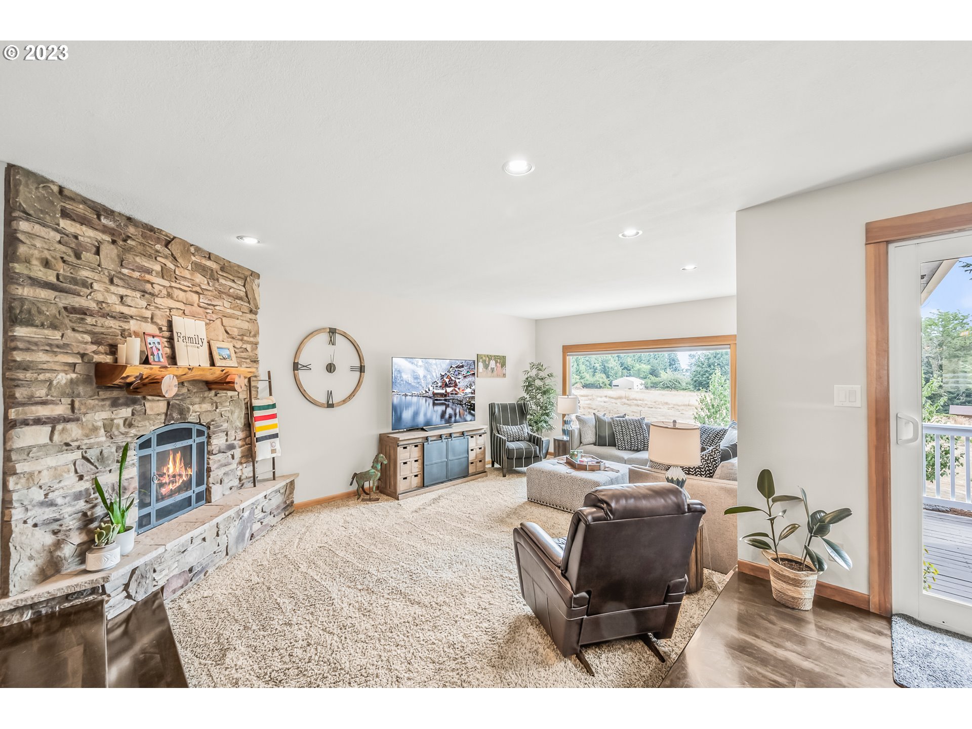 32311 Viewcrest Drive Warren, OR 97053 - Photo 9 of 46 a living room with furniture a large window and a flat screen tv