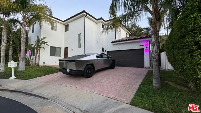 a car parked in front of white house