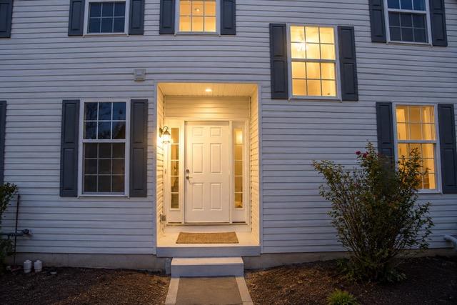 5439 Spring Ridge Drive West Macungie, PA 18062 - Photo 2 of 17 A welcoming recessed entry features a classic paneled door flanked by symmetrical shuttered windows.
