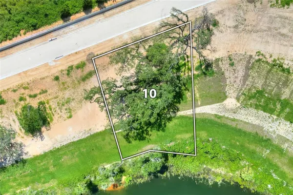 an aerial view of a golf course with lake view