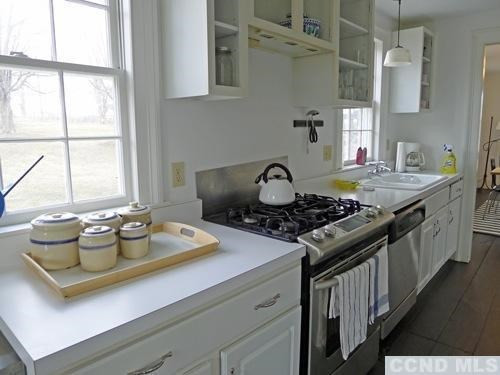 17 High Meadow Road Copake, NY 12516 - Photo 4 of 10 a kitchen with a stove and a window