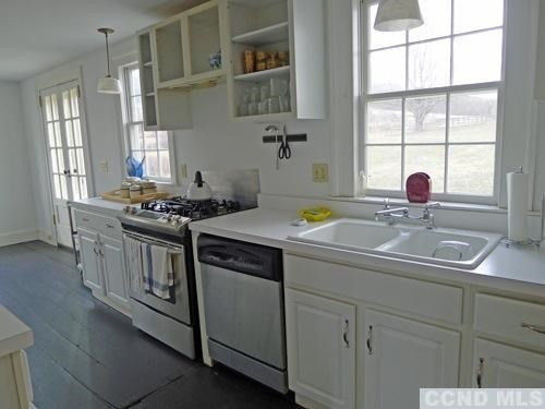 17 High Meadow Road Copake, NY 12516 - Photo 5 of 10 a kitchen with kitchen island a sink stove and window