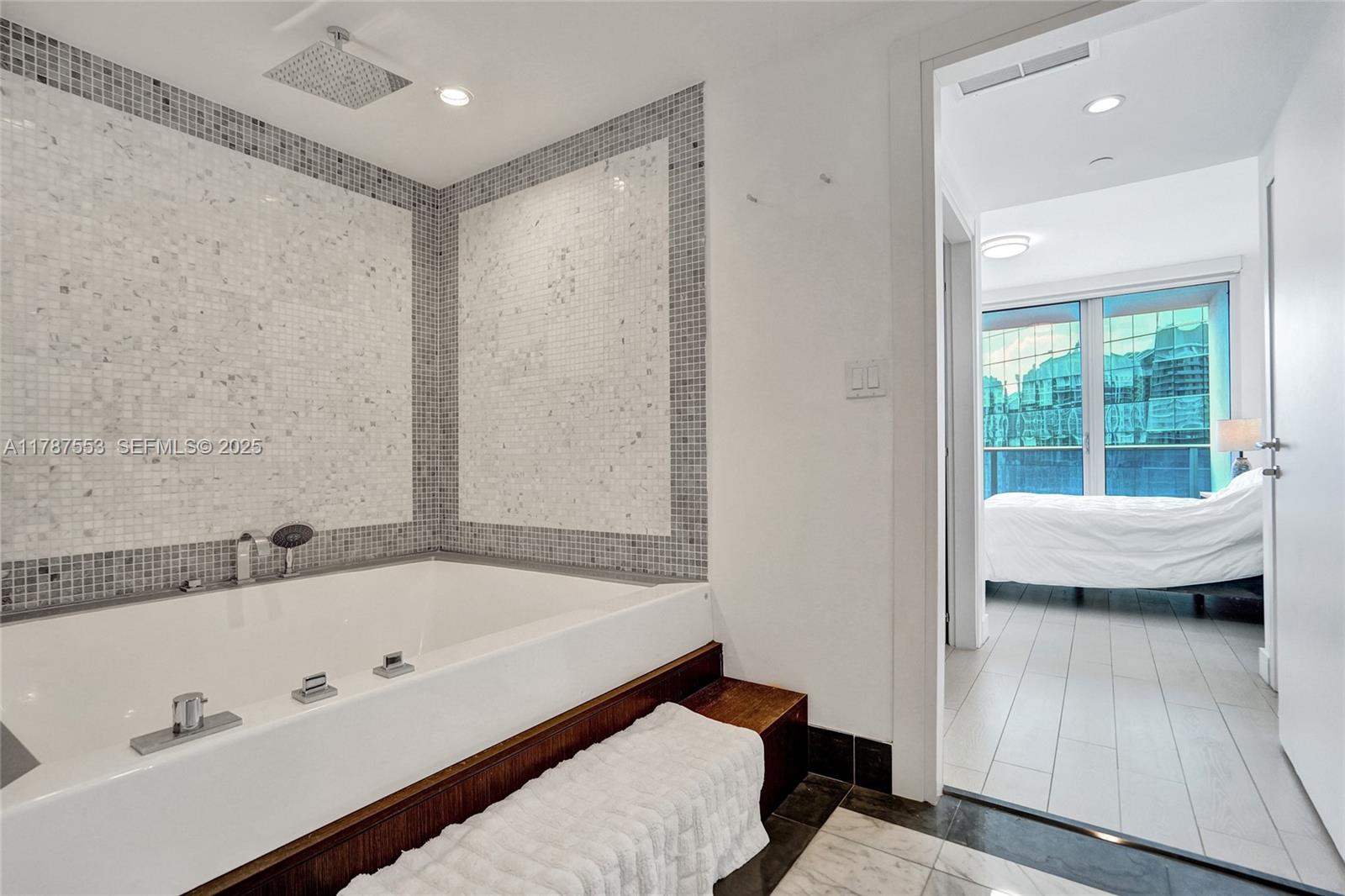 200 Biscayne Blvd Way, Unit 3211 Miami, FL 33131 - Photo 15 of 27 a bathroom with a tub and a window